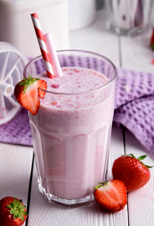 protein shake with strawberries and a straw