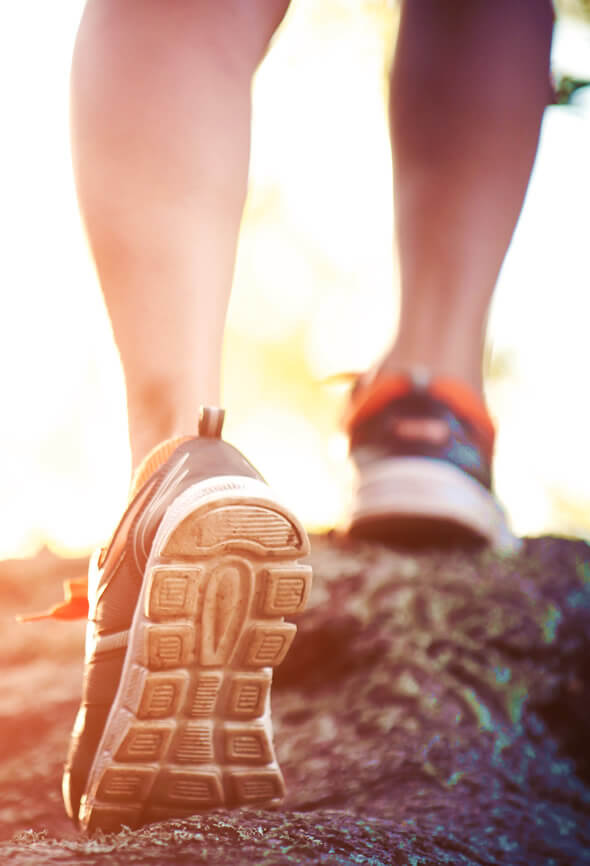 woman legs while doing walking challenge on a mountain