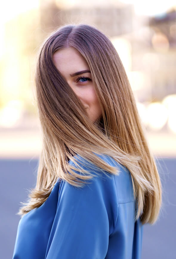 woman looking playful after her hair spa day