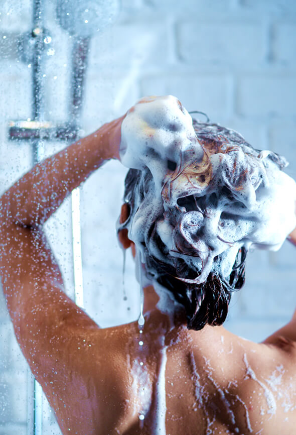 woman shampooing her hair on a hair spa day