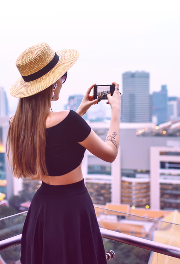 woman taking pictures on the roof top