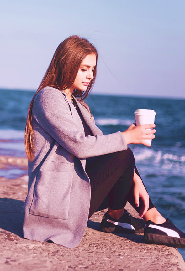 woman with atelophobia sitting by the sea