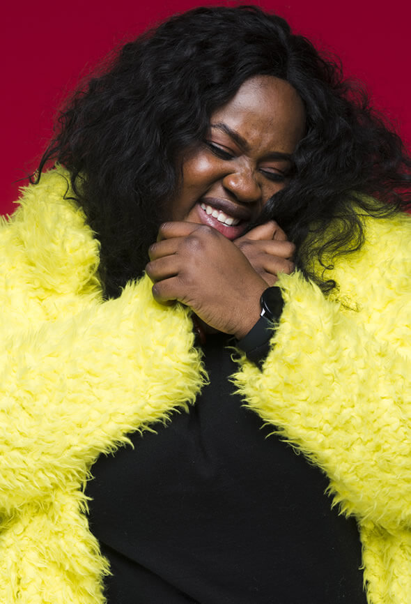 curvy black woman cheering up for herself to boost her motivation to lose weight
