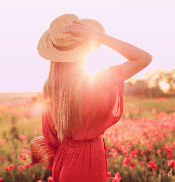 woman walking in the field of sun