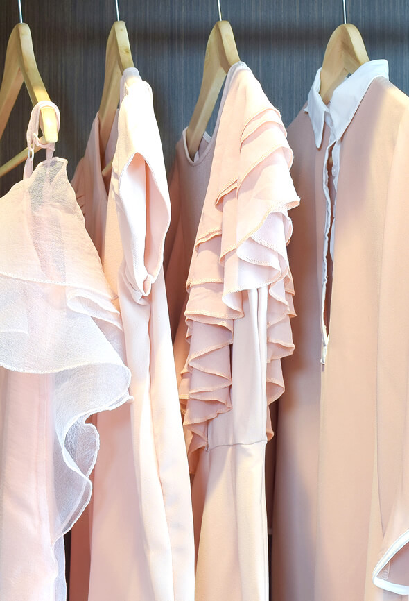 various pink blouses on a hanger