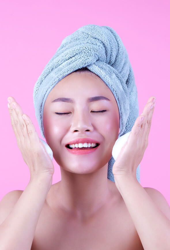 woman cleansing her face before face yoga session