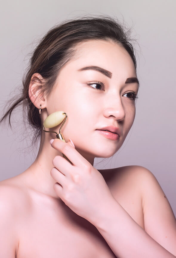 woman giving herself a gua sha massage