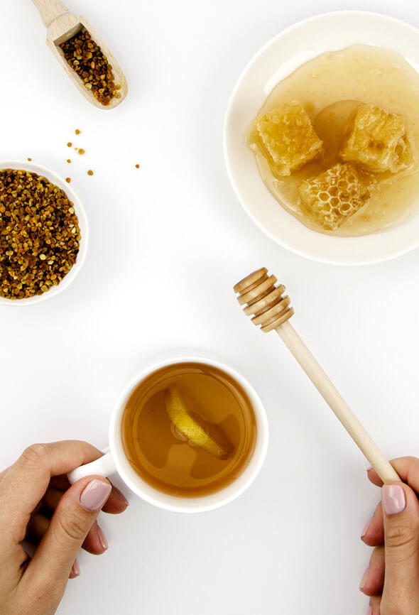 woman making tea with manuka honey and lemon