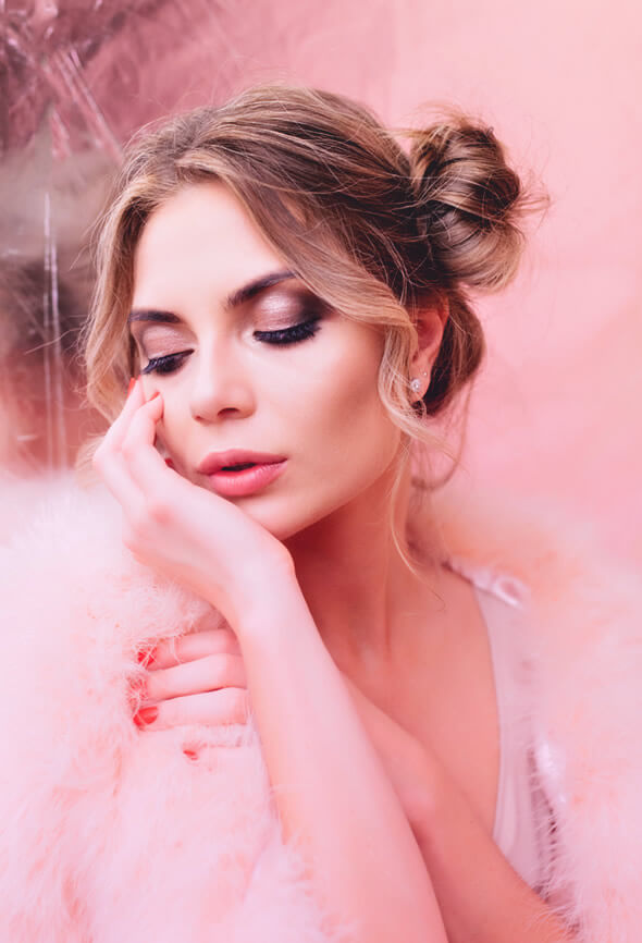 woman thinking how to lose face fat in a pink room