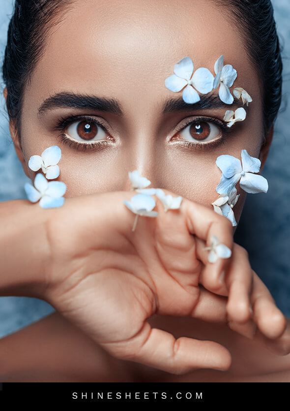 gorgeous woman with flowers on her face as an illustration of empowering attitude quotes for girls