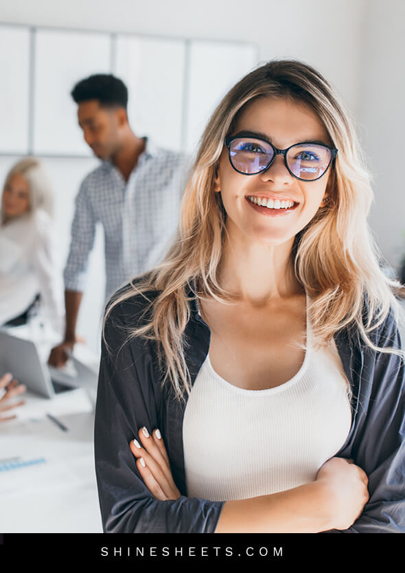 pretty smiling woman with glasses as a symbol of nice and professional social etiquette at work