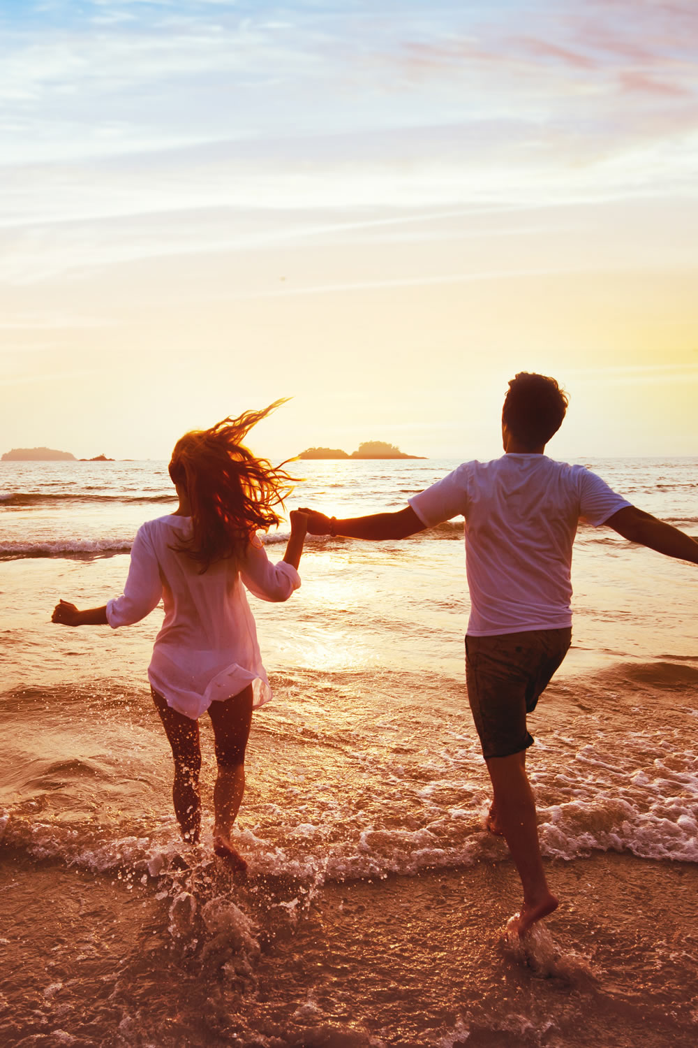 boy and girl having great couple tiem together on the beach