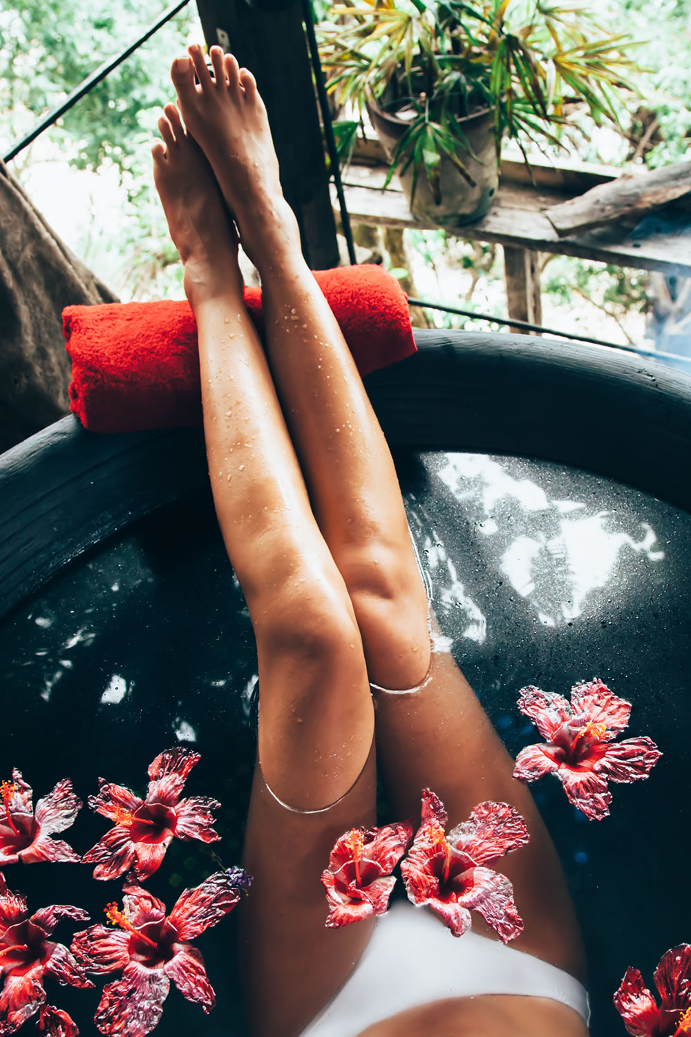 Woman taking Epsom salt and vitamin C bath to take care of her skin and feel more feminine.