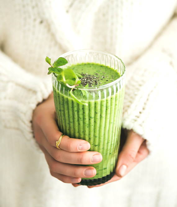 girl with orthorexia holding a green drink in her hands