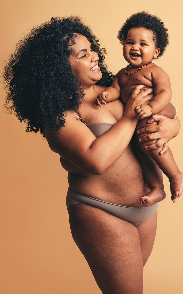 natural beauty african american woman with a baby in her hands