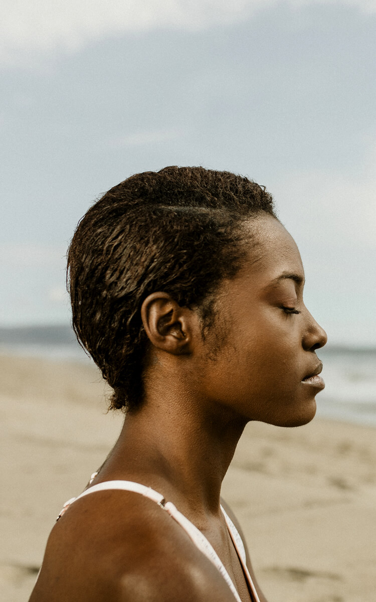 pretty black woman meditating to overcome self-destructive behavior