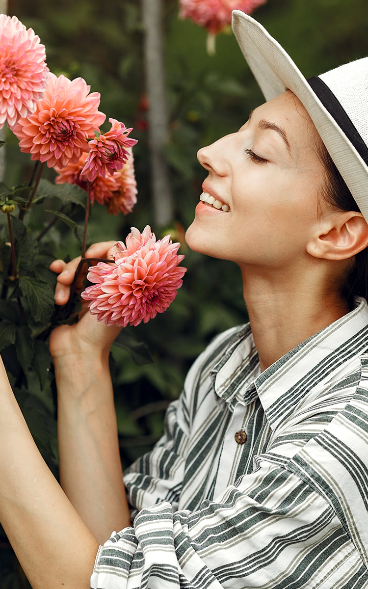 woman enjoying flowers in her garden