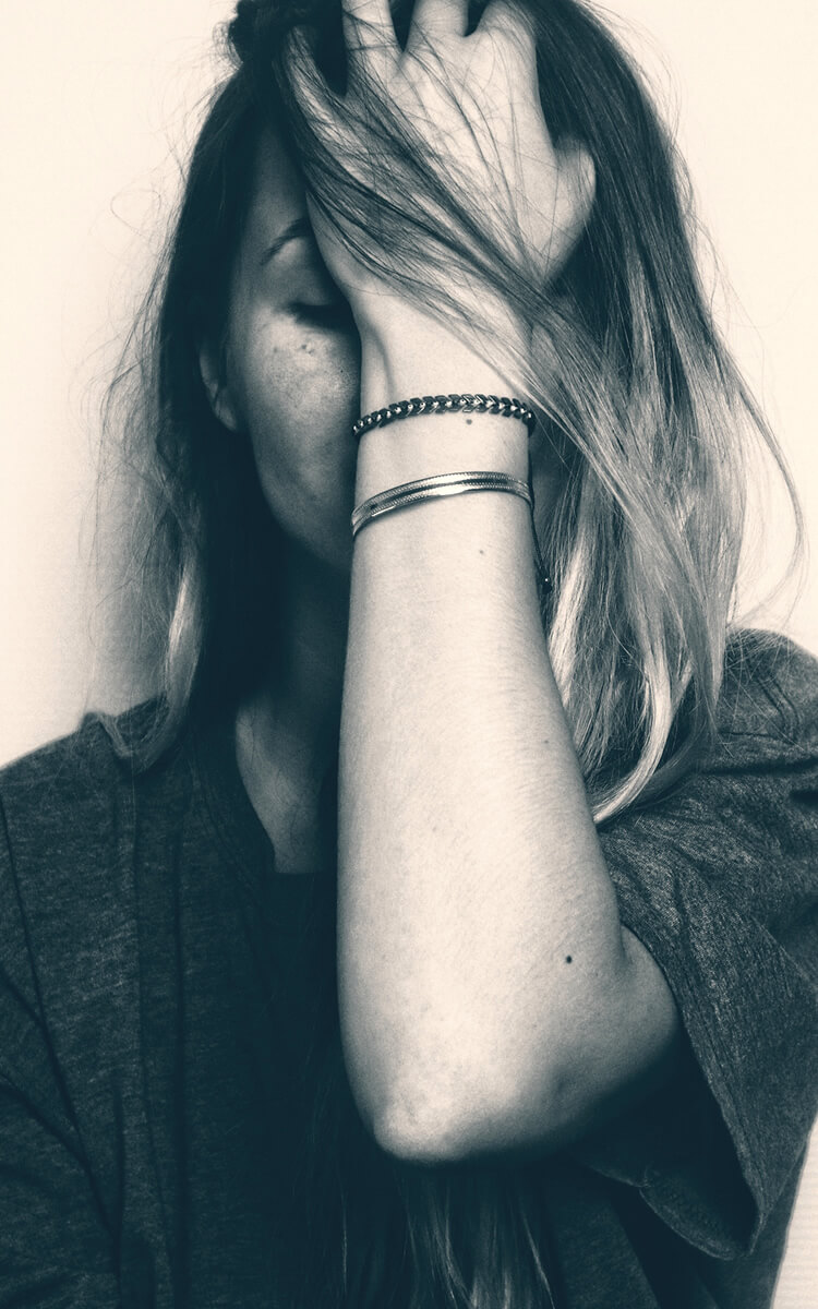 woman feeling sad emotions that trigger self-destructive behavior