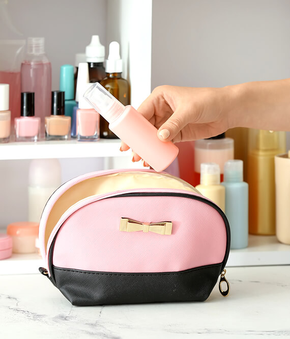 woman packing skincare for travel