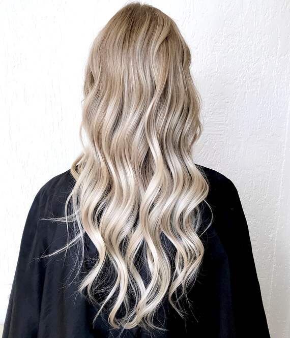 woman with perfect blond hair asking hairdresser "when can I bleach my hair again?"