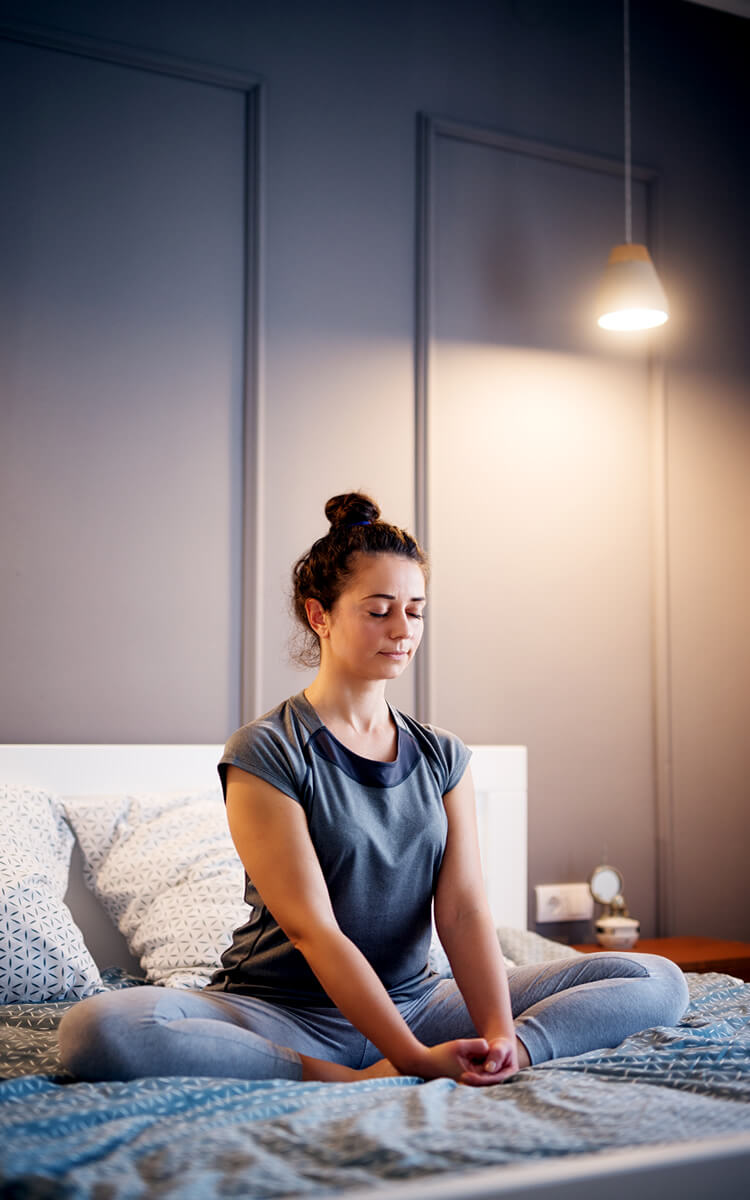 woman meditating to relax before bed