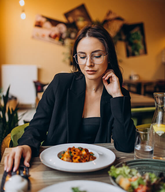 woman showing signs that you are not eating enough
