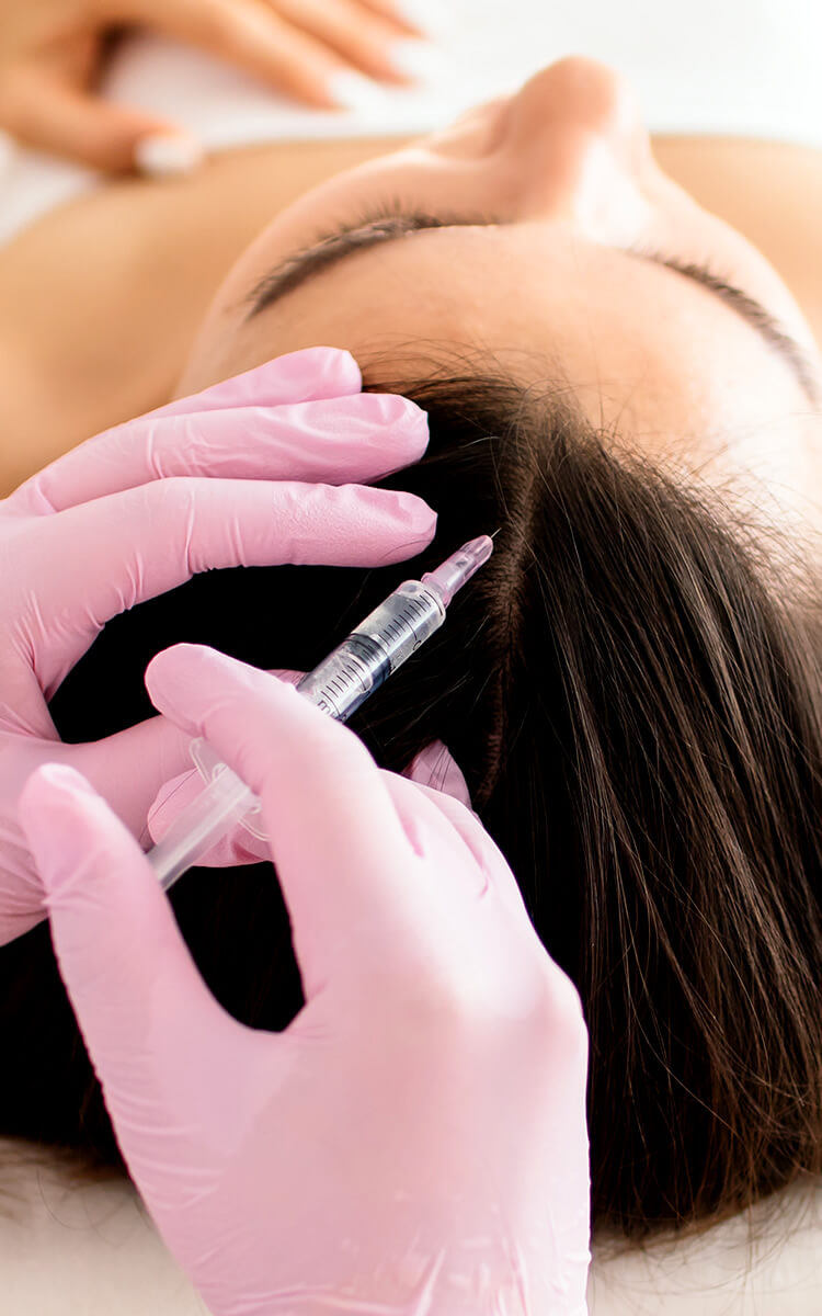 dermatologist performing mesotherapy for hair loss in a salon