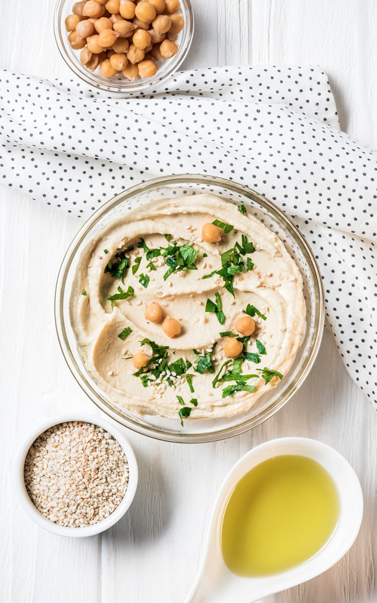 hummus with olive oil sesame seeds and chickpeas on the table