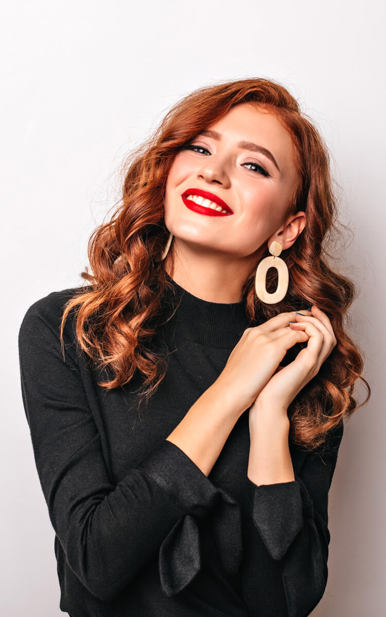 redhead woman with curled hollywood style hair