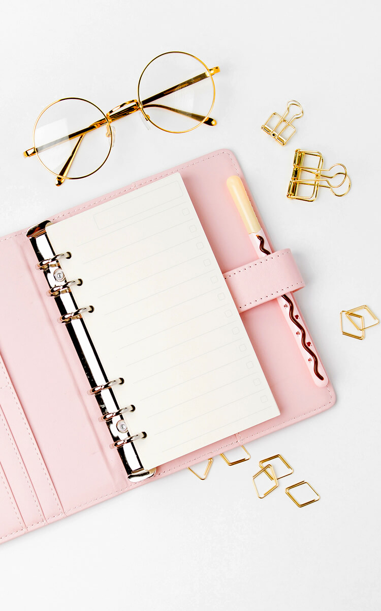 schedule planner on the table and glasses