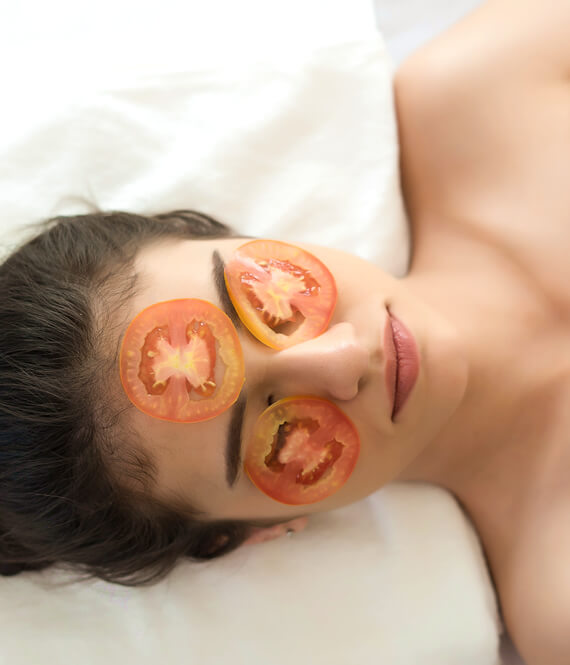woman relaxing with tomato skincare mask