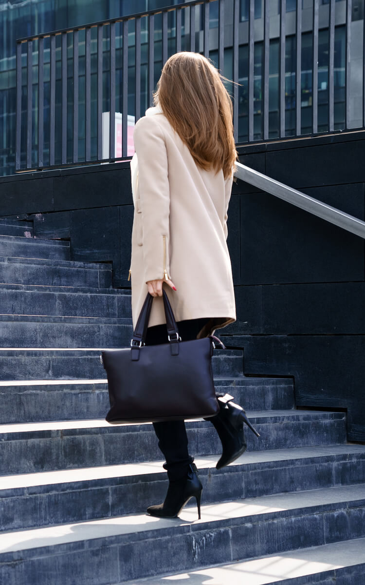 woman climbing steps to success