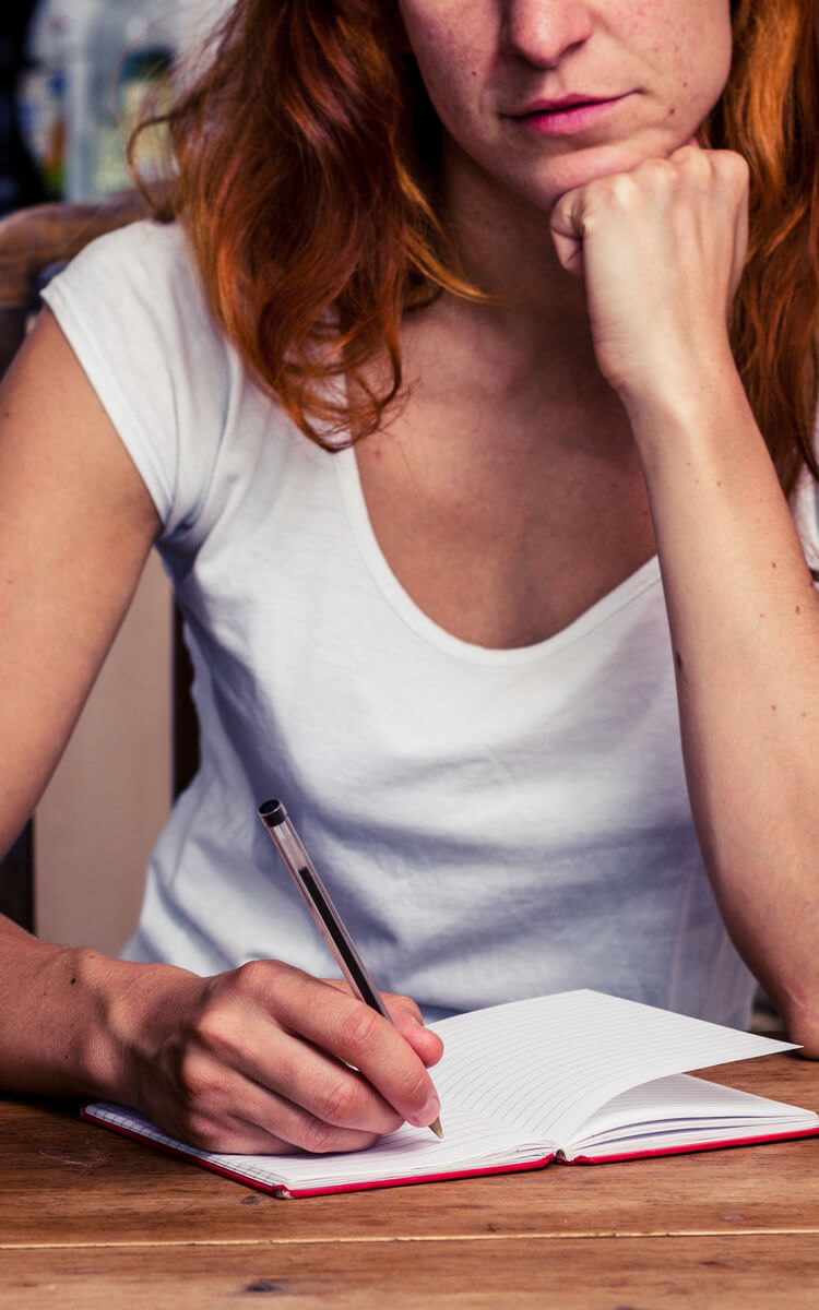 woman making a list of positive things in her life
