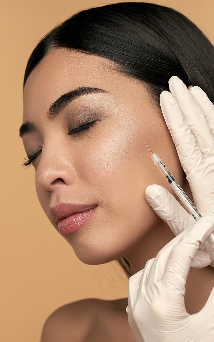 a pretty woman getting botox treatment for wrinkles