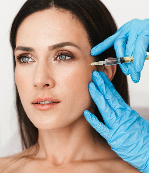 a woman gets botox injections for wrinkles on her face