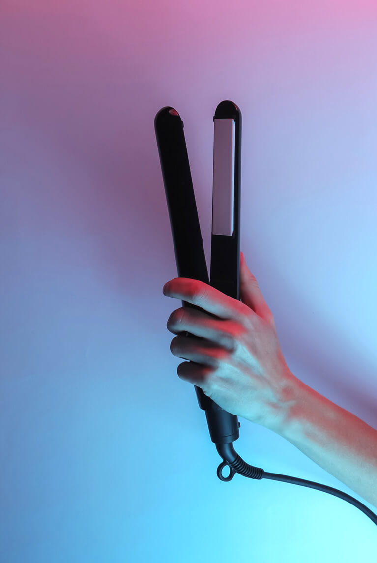 hand holding a hair straightener