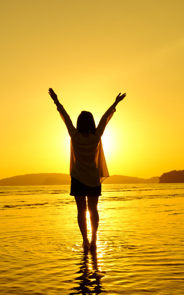 hopeful woman playing in the sunset