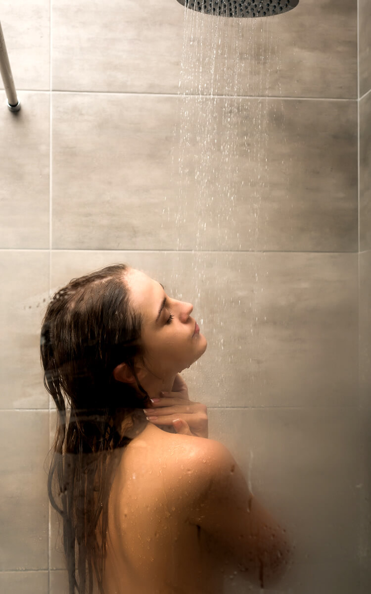 woman having a relaxing shower before sleep