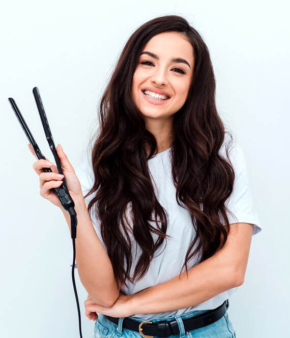woman with beach waves in her hair creater with flat iron