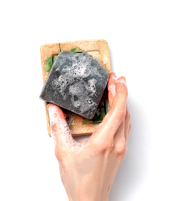 woman holding tea tree soap