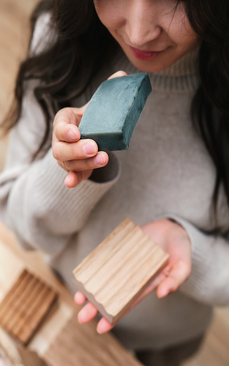 woman smelling tea tree soap