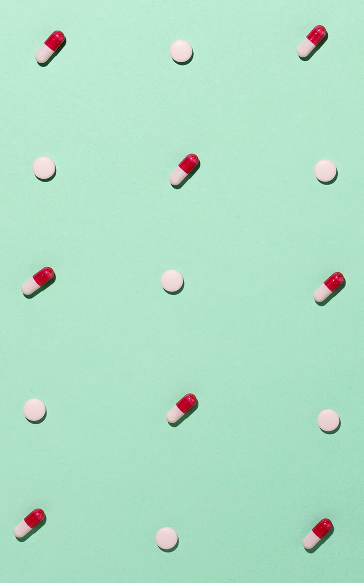 medicine pills and tablets on green table