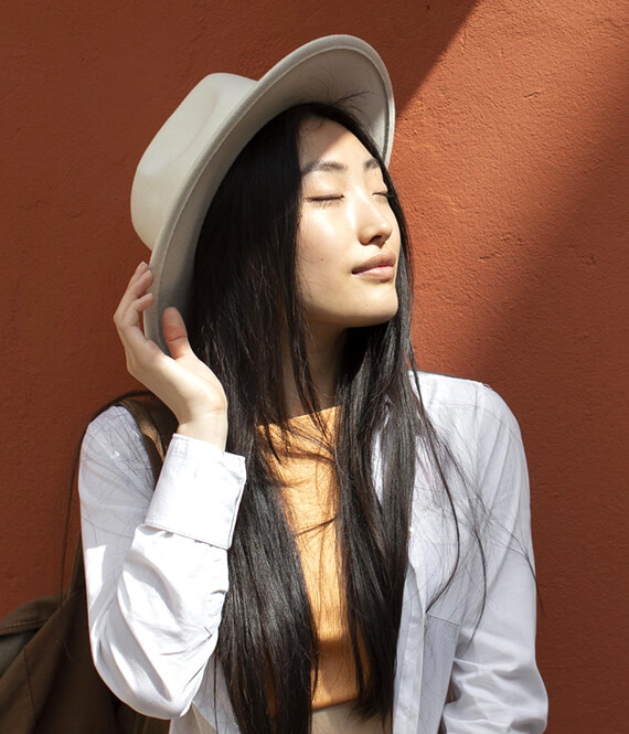 pretty asian woman with glowing skin after preventative botox treatment