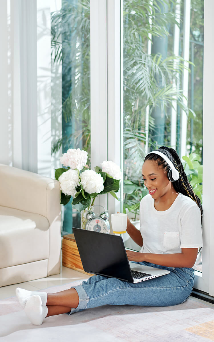 pretty black woman doing a freelance job on her laptop