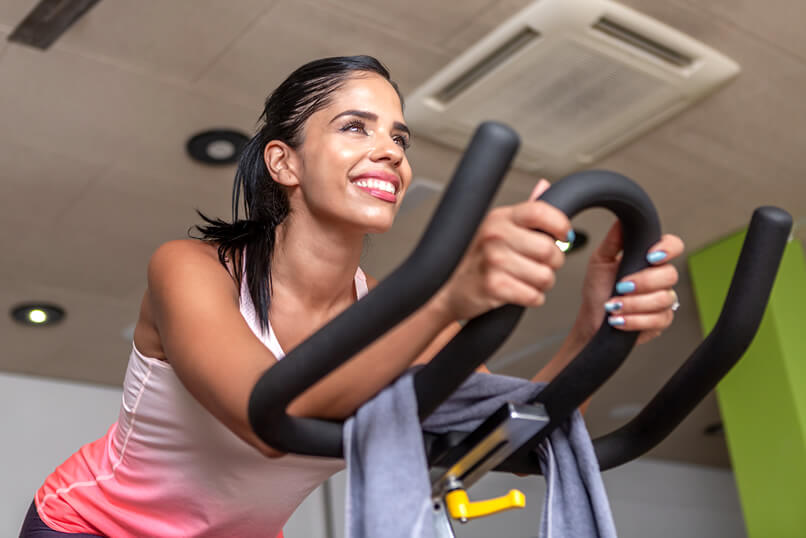 woman cycling indoors