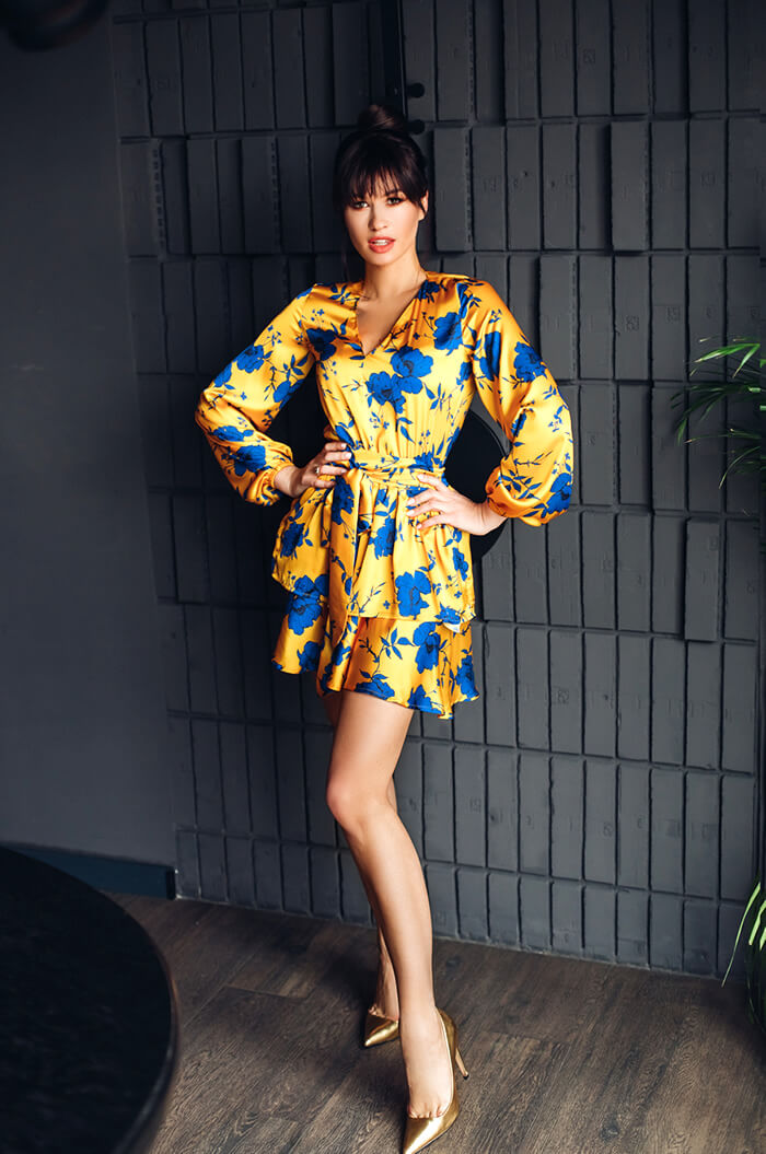 woman in yellow dress taking instagram pictures
