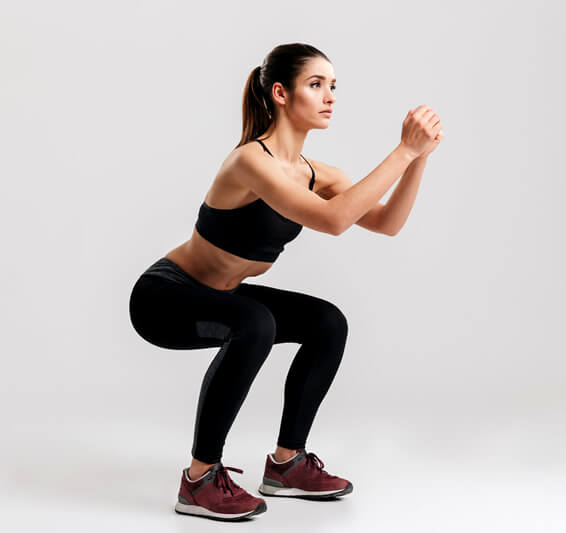 woman showing proper squats form