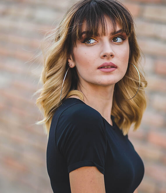 woman with flat iron curly hairstyle