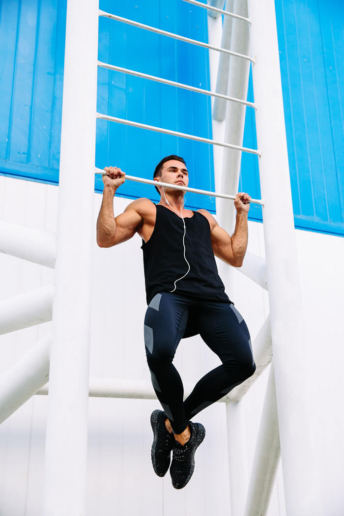 young man showing how to do pull ups with proper form
