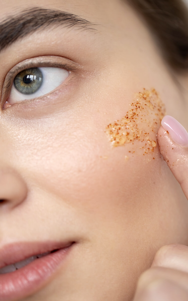 young white woman using scrub on her facial skin